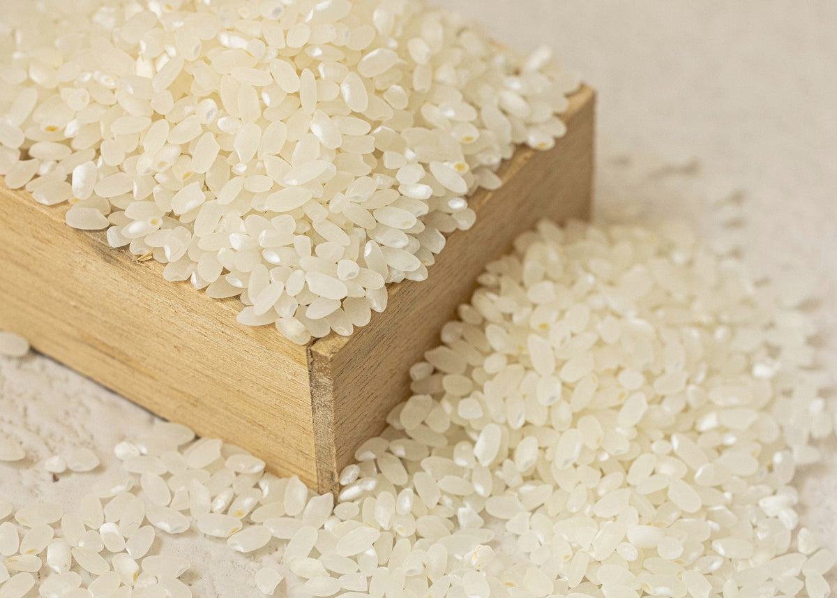 a wooden block with white rice on it