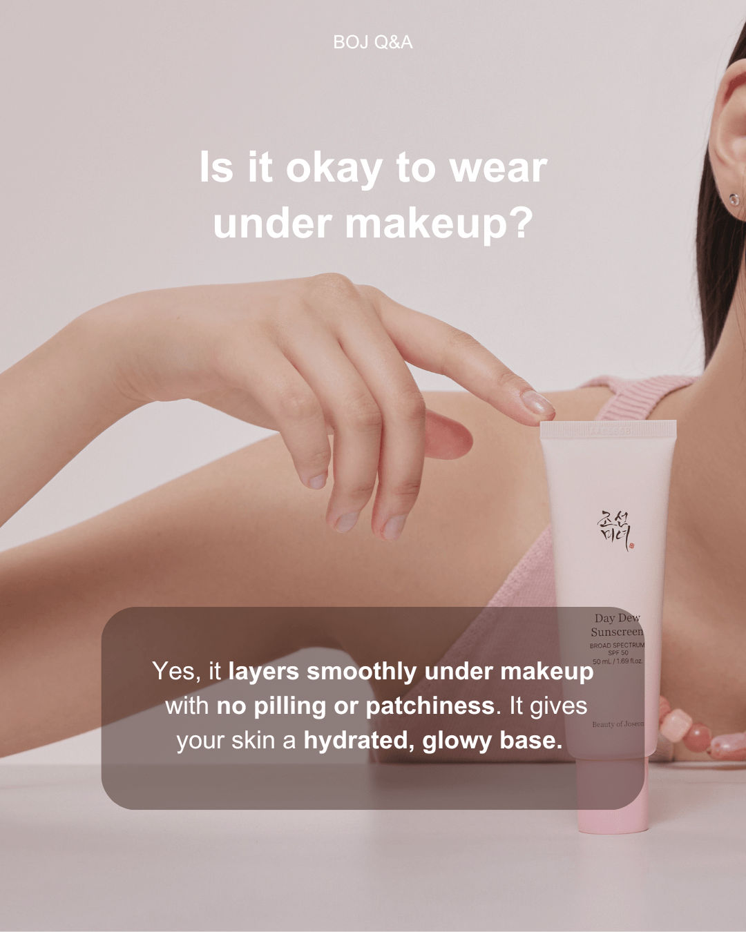a woman pointing at a tube of makeup