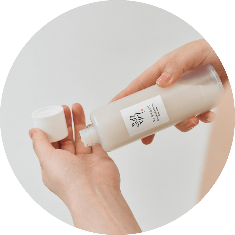 a person holding a bottle of liquid