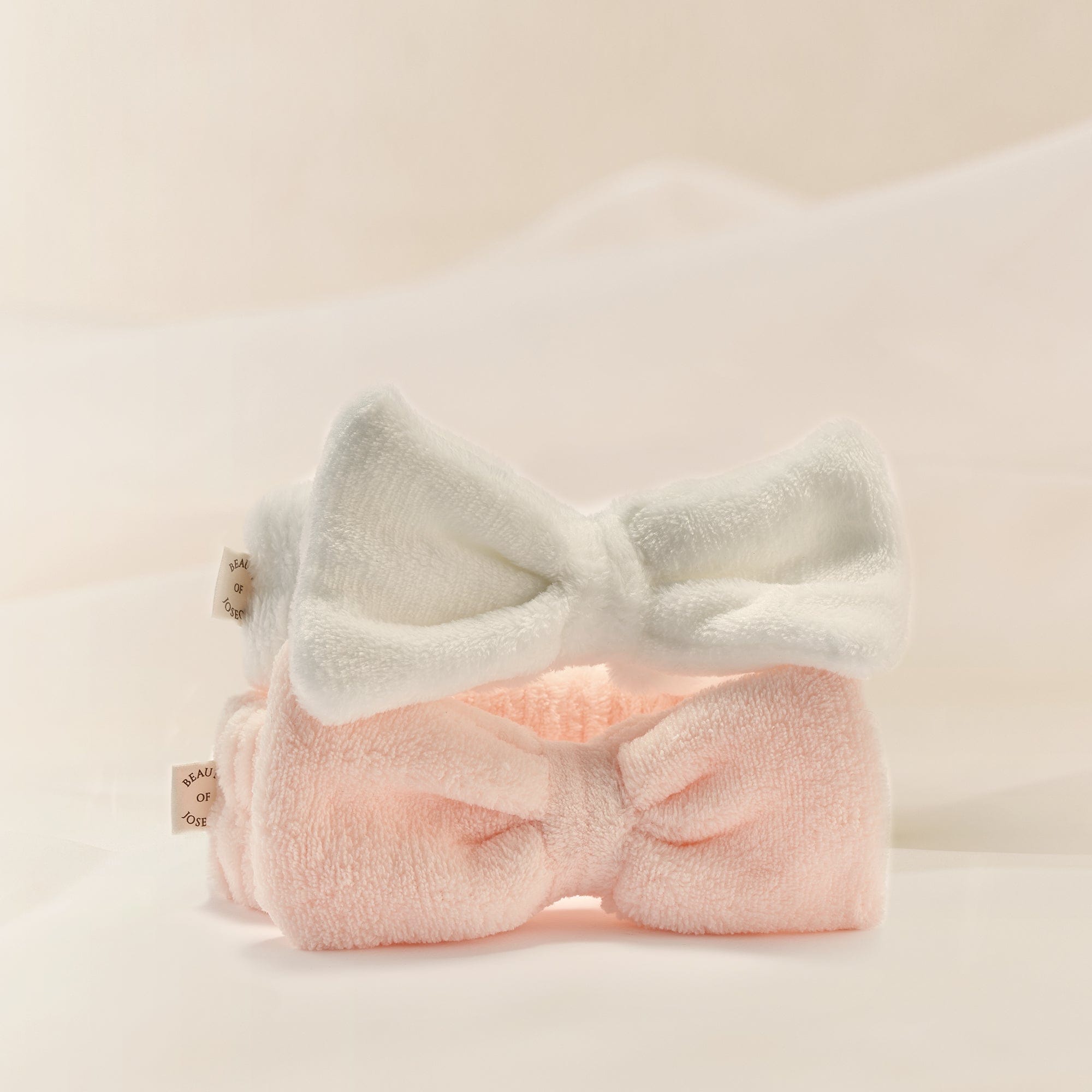 a pair of pink and white hair bands
