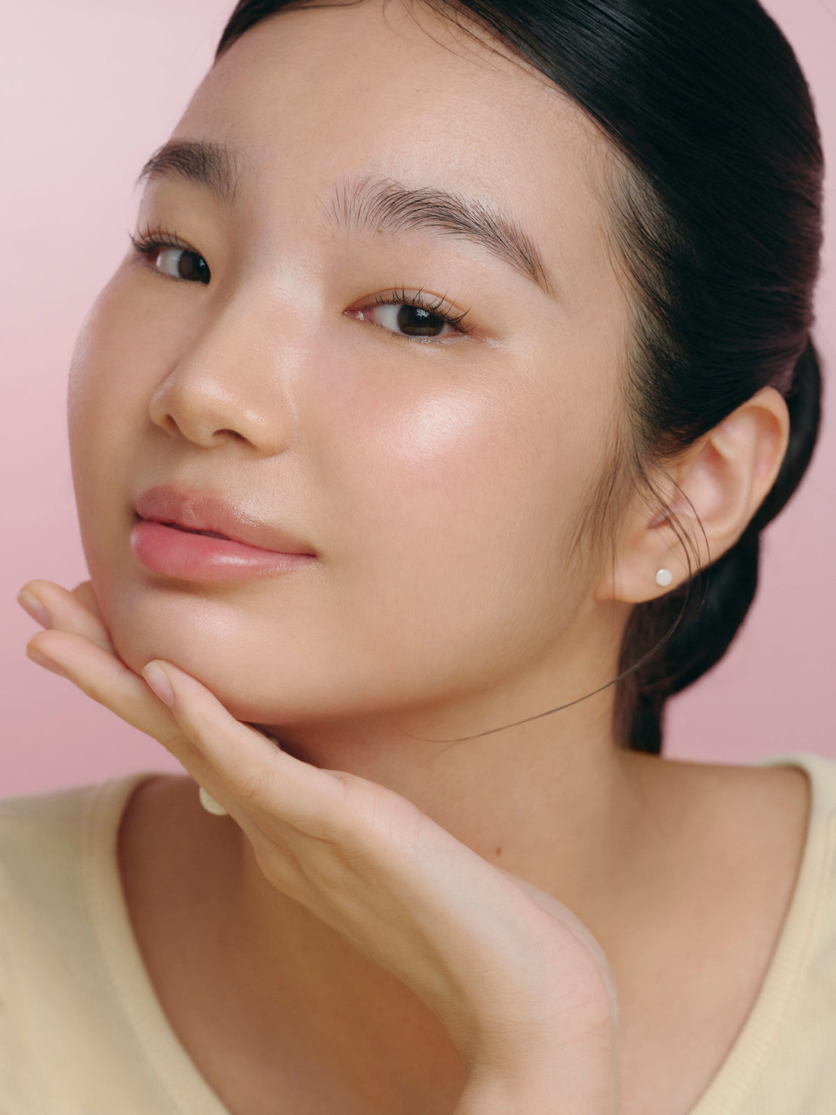 a woman with her hand on her face