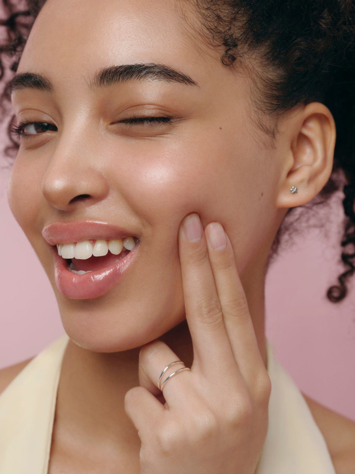 a woman with her hand on her cheek