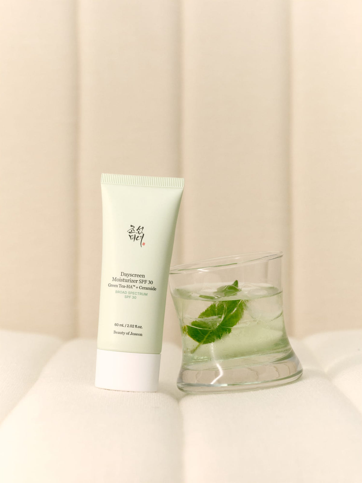 a bottle of gel next to a glass of water