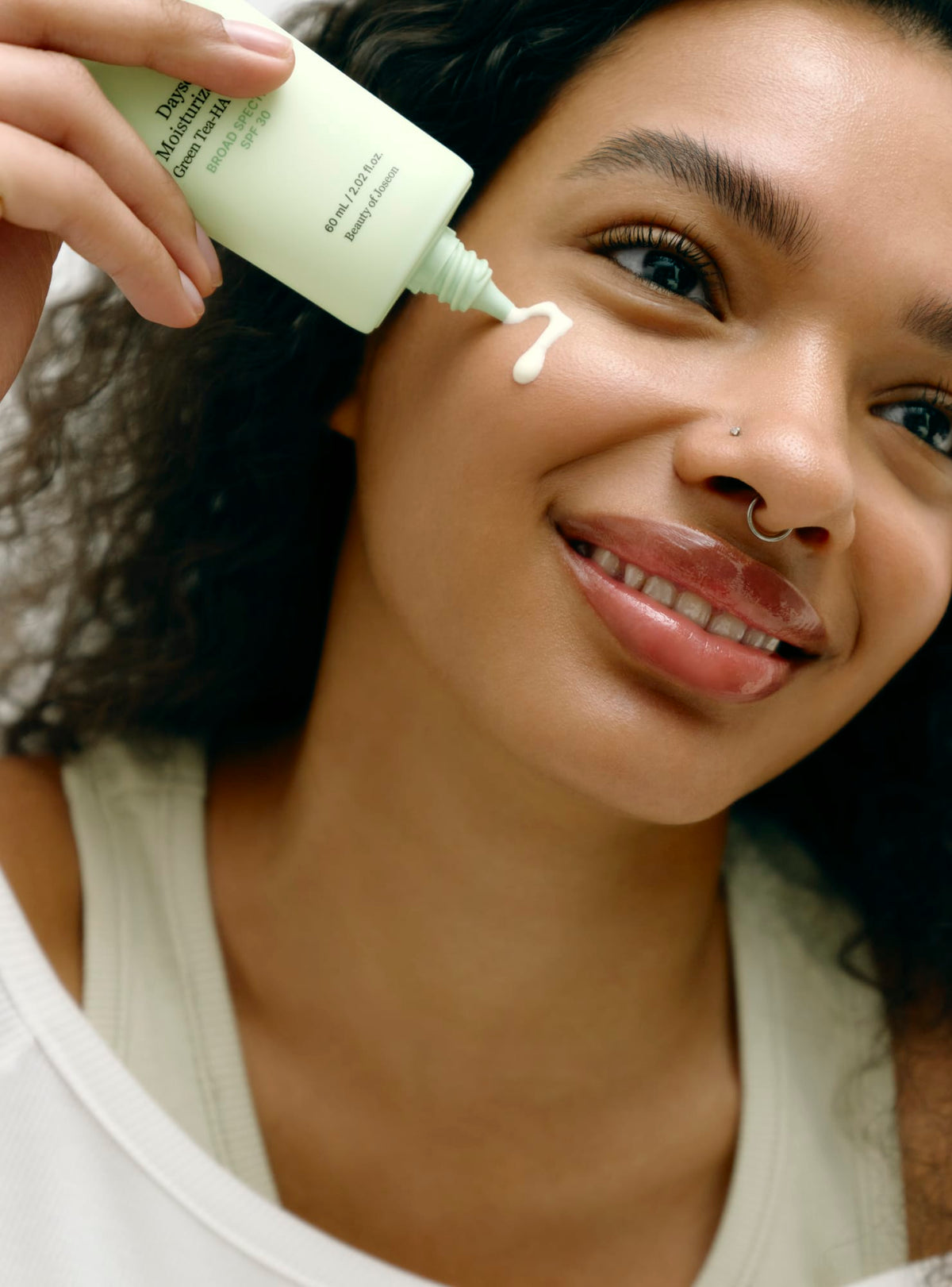 a woman applying a face cream