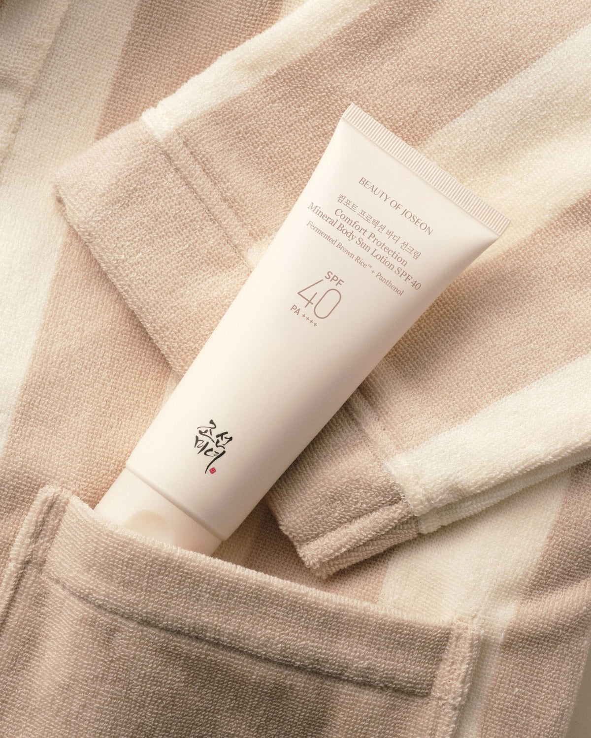 a cream tube in a pocket of a towel