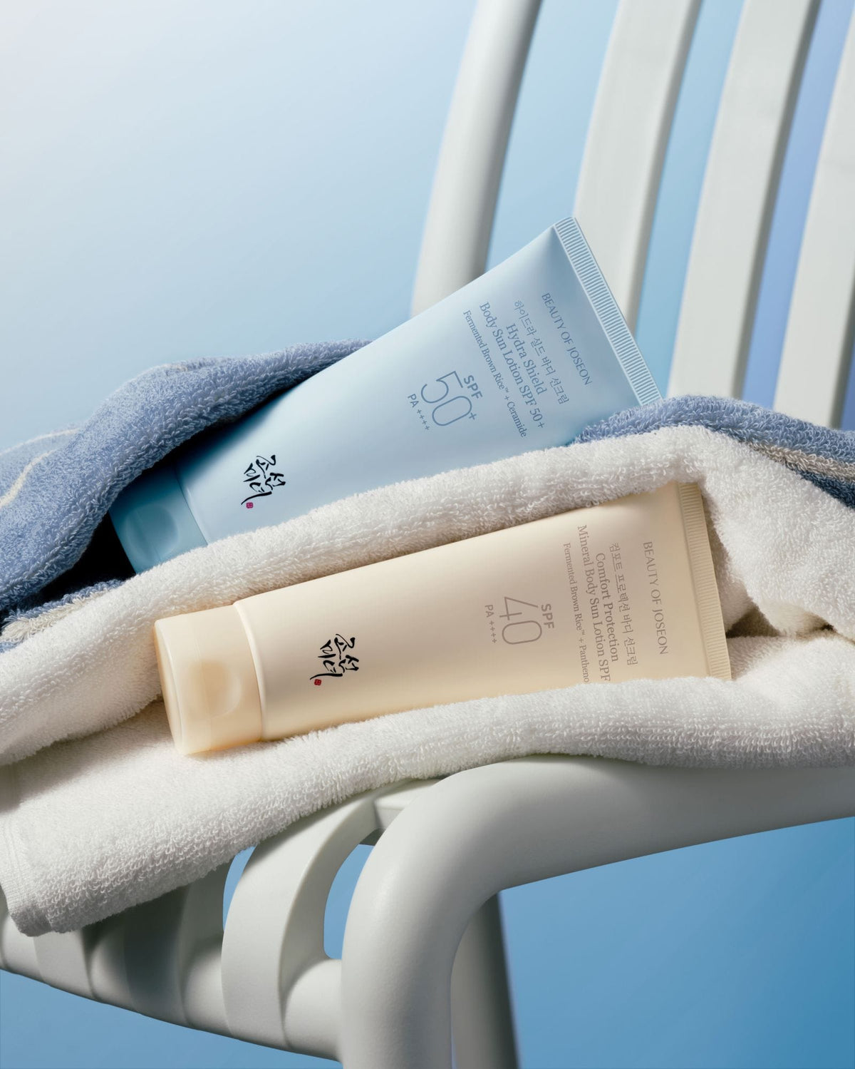 a towel and bottles of cream on a white towel