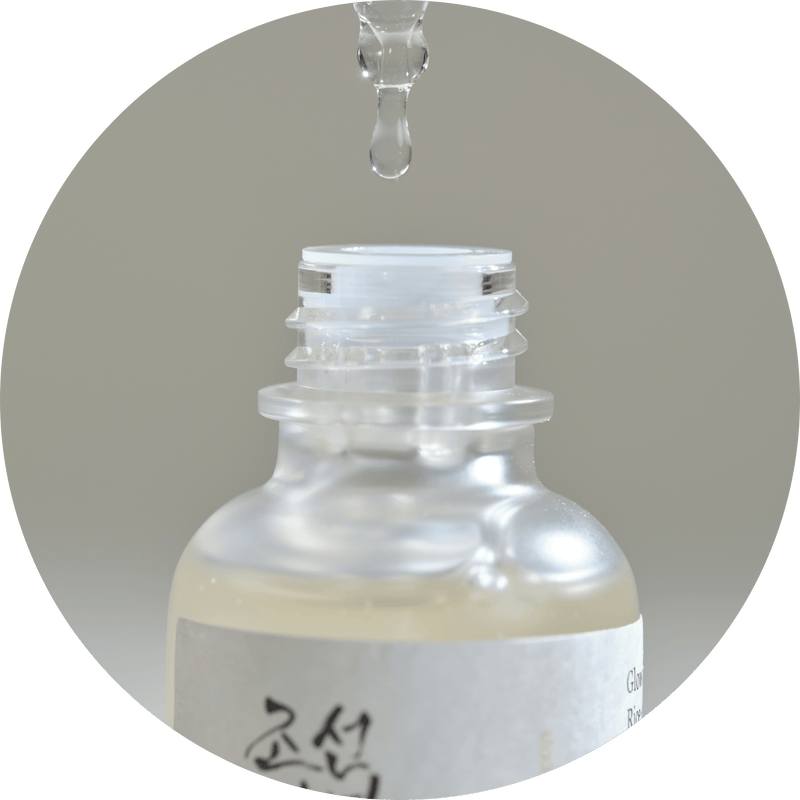 a drop of water falling from a drop of liquid into a bottle