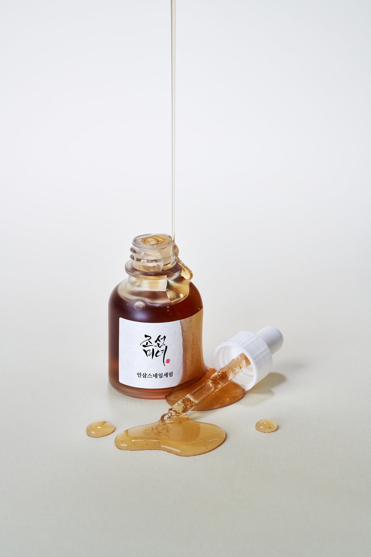 a bottle of liquid pouring out of a dropper