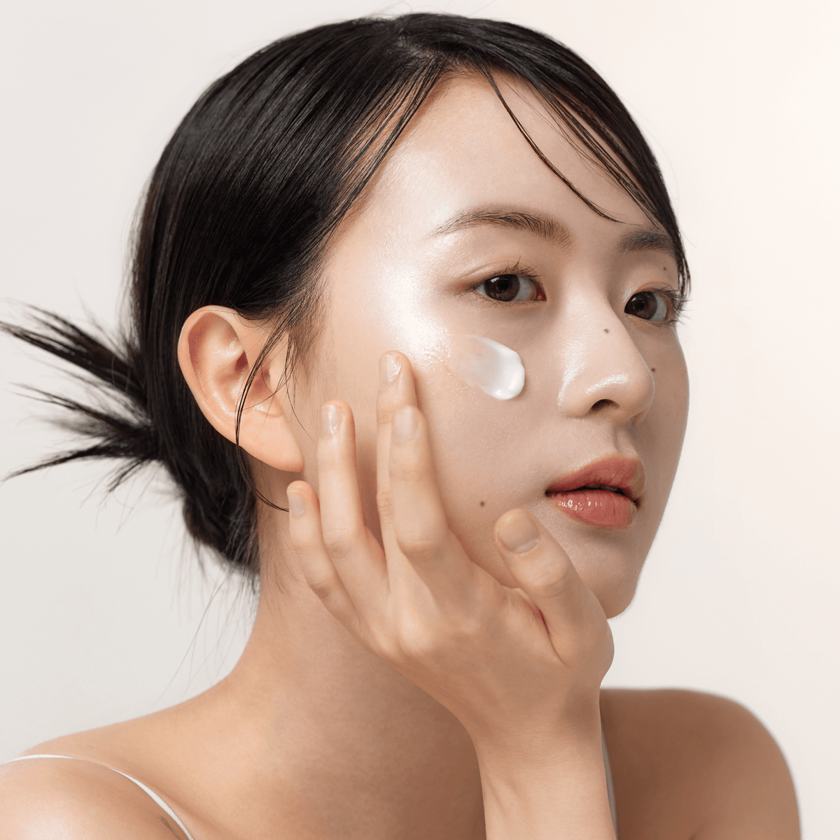 a woman with a white cream on her face