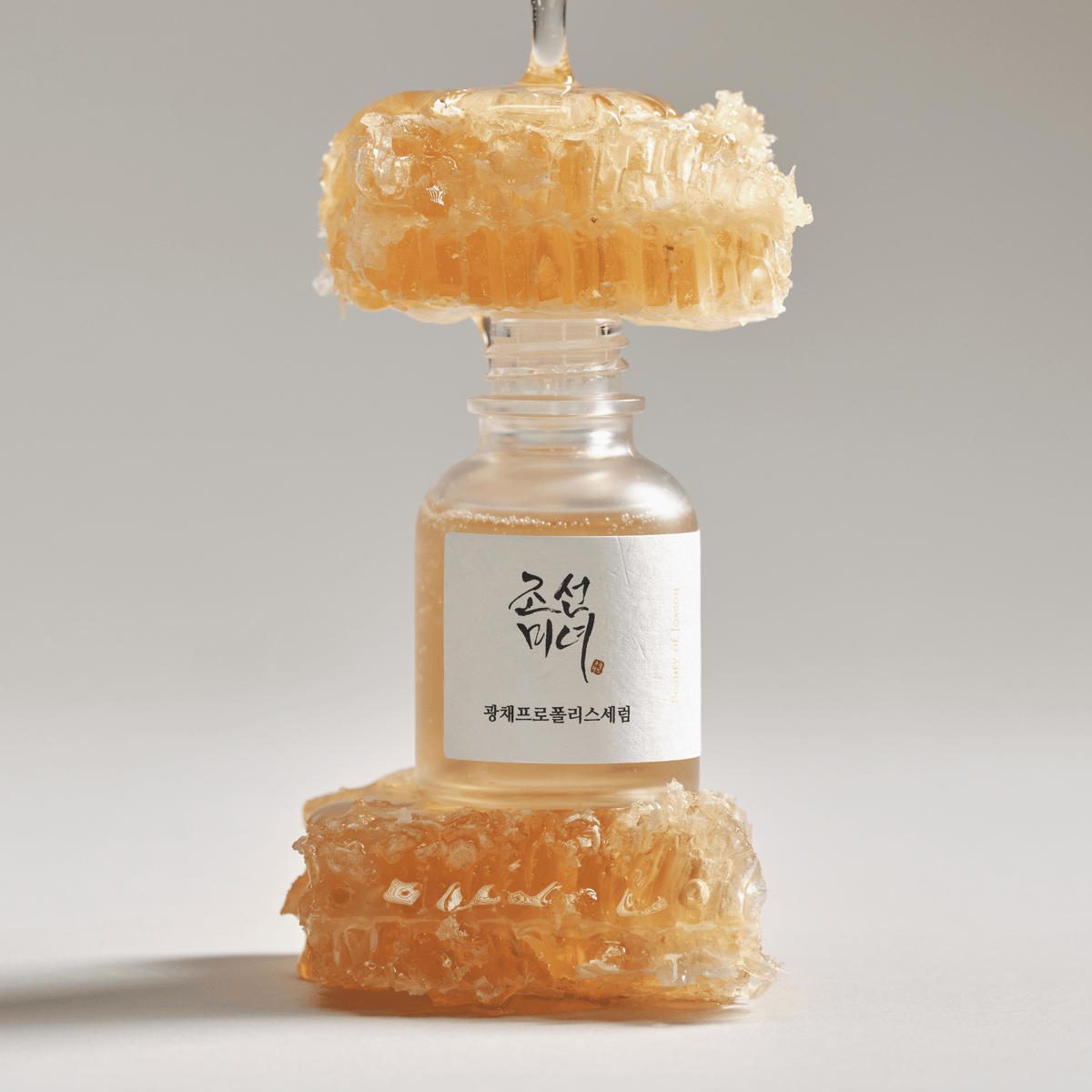 a bottle with honeycombs on top