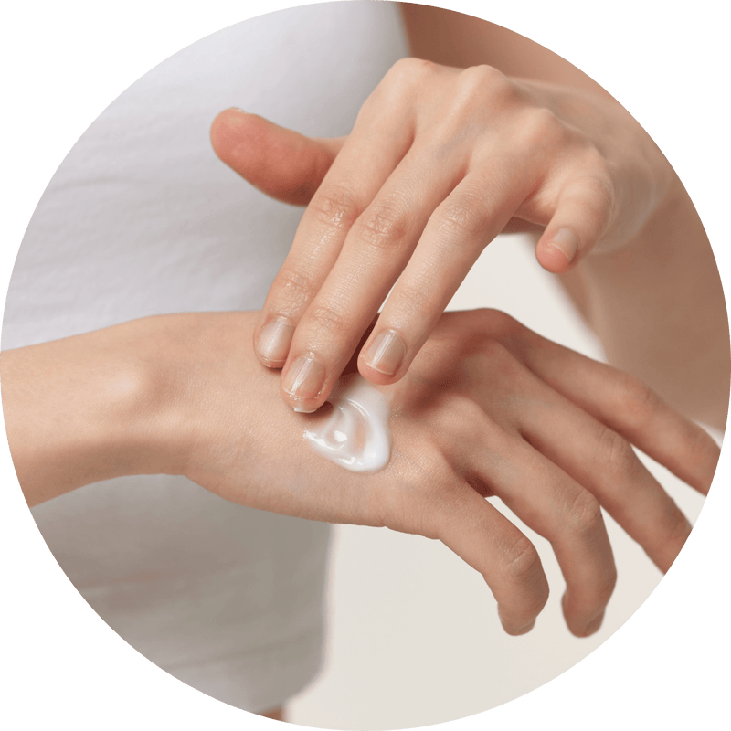 a close-up of hands applying cream