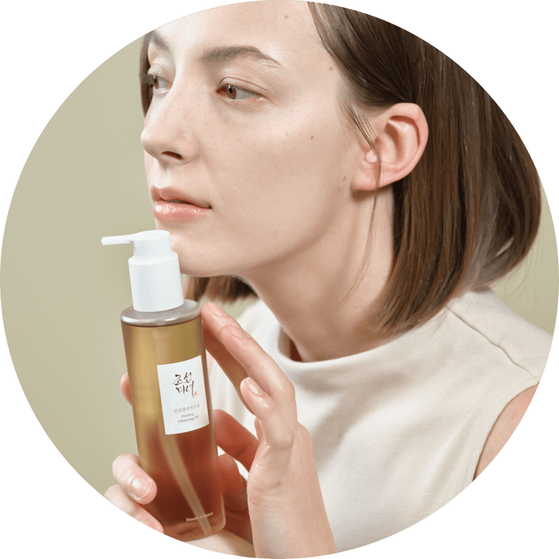 a woman holding a bottle of liquid
