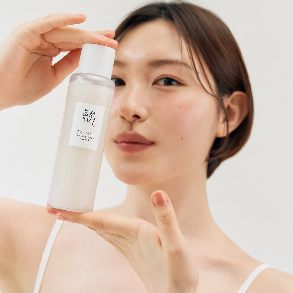a woman holding a bottle of lotion