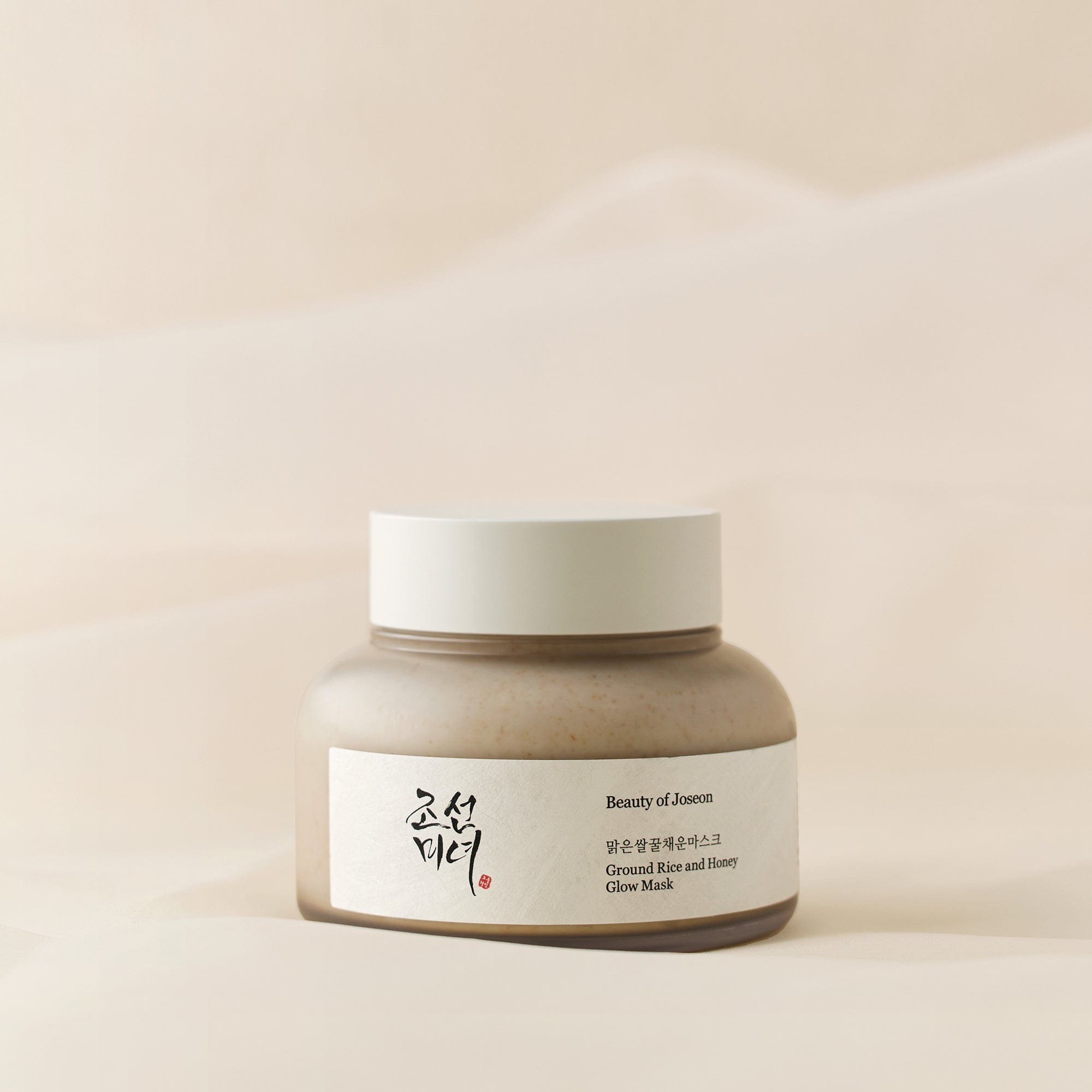 a jar of cream on a white surface