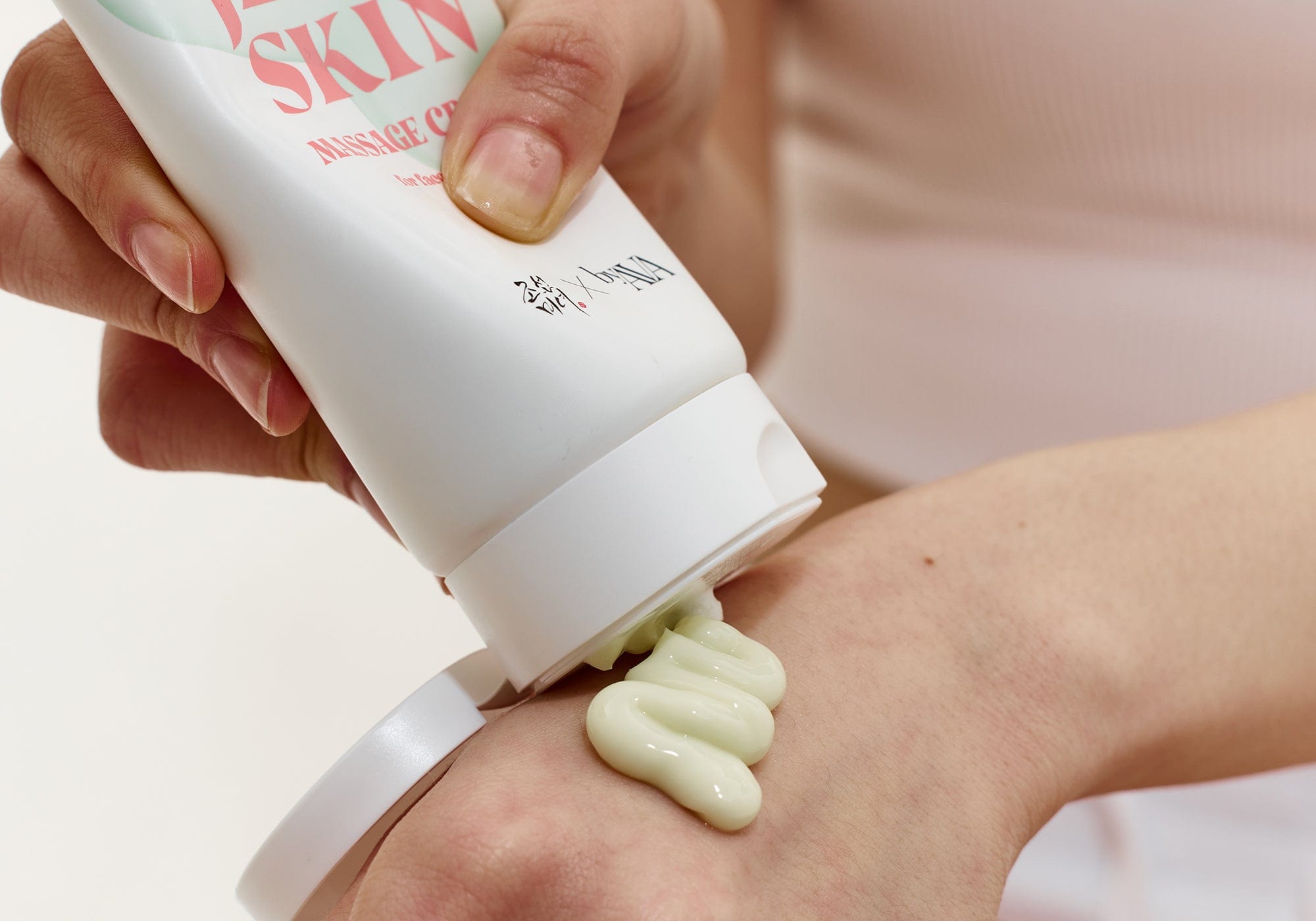 a person applying a cream on their hand