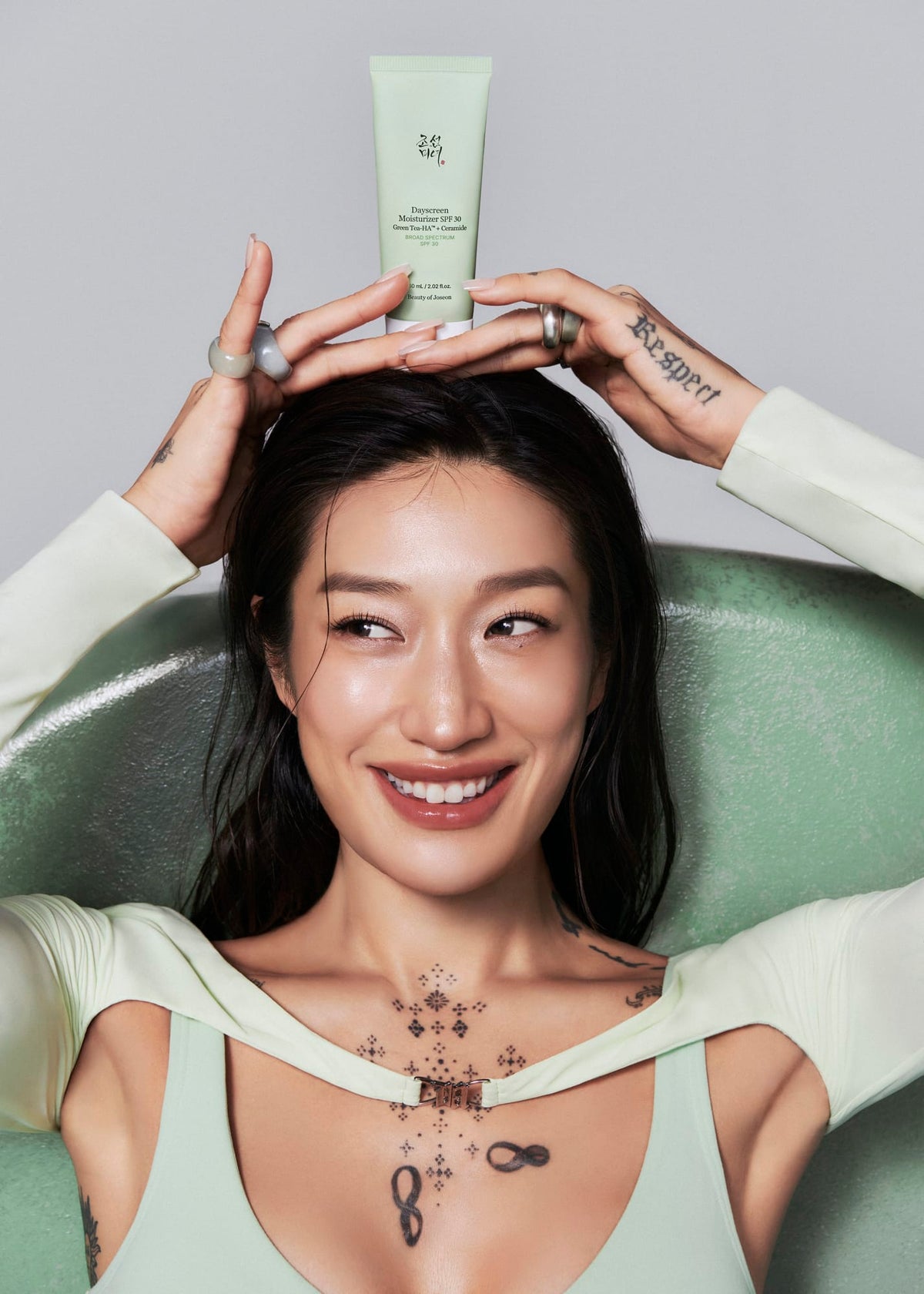 a woman holding a bottle of cream