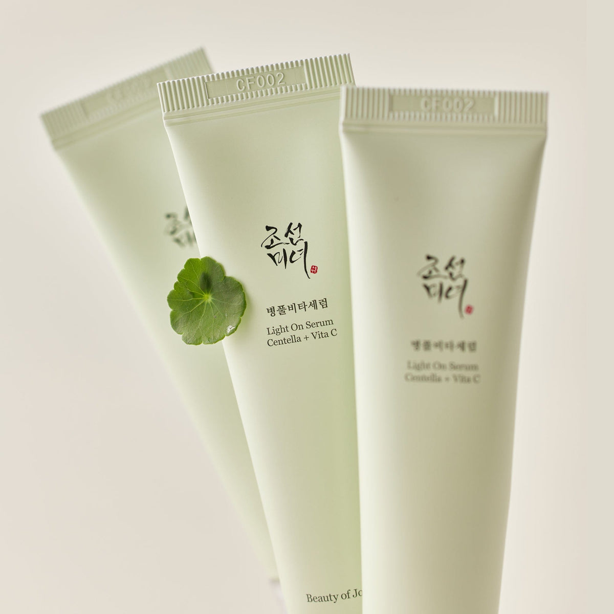 a group of white tubes with green leaves