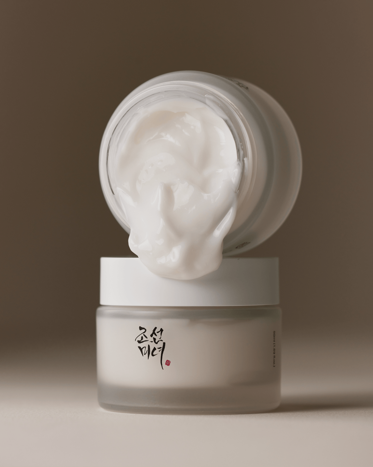 a white jar with a white lid and a white container with a white lid