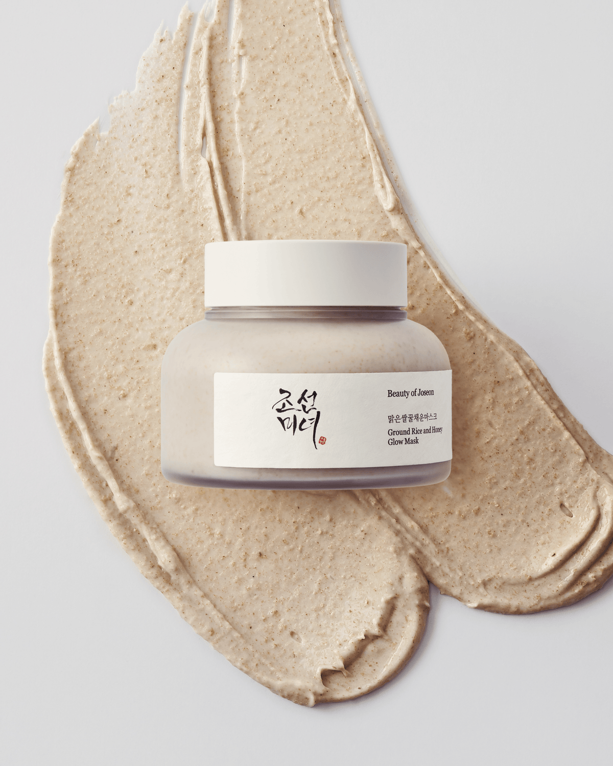 a jar of cream on a white surface