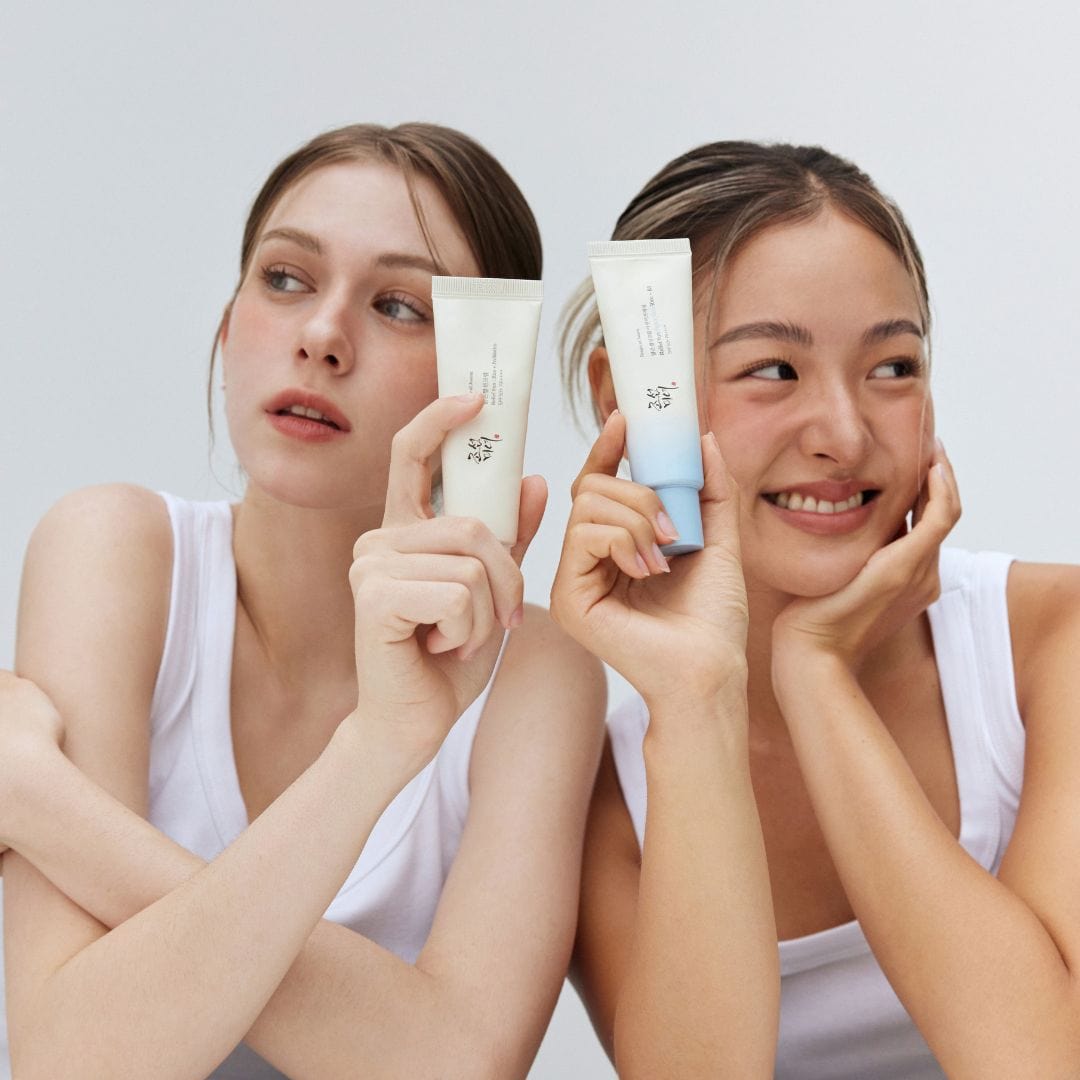 two women holding up creams