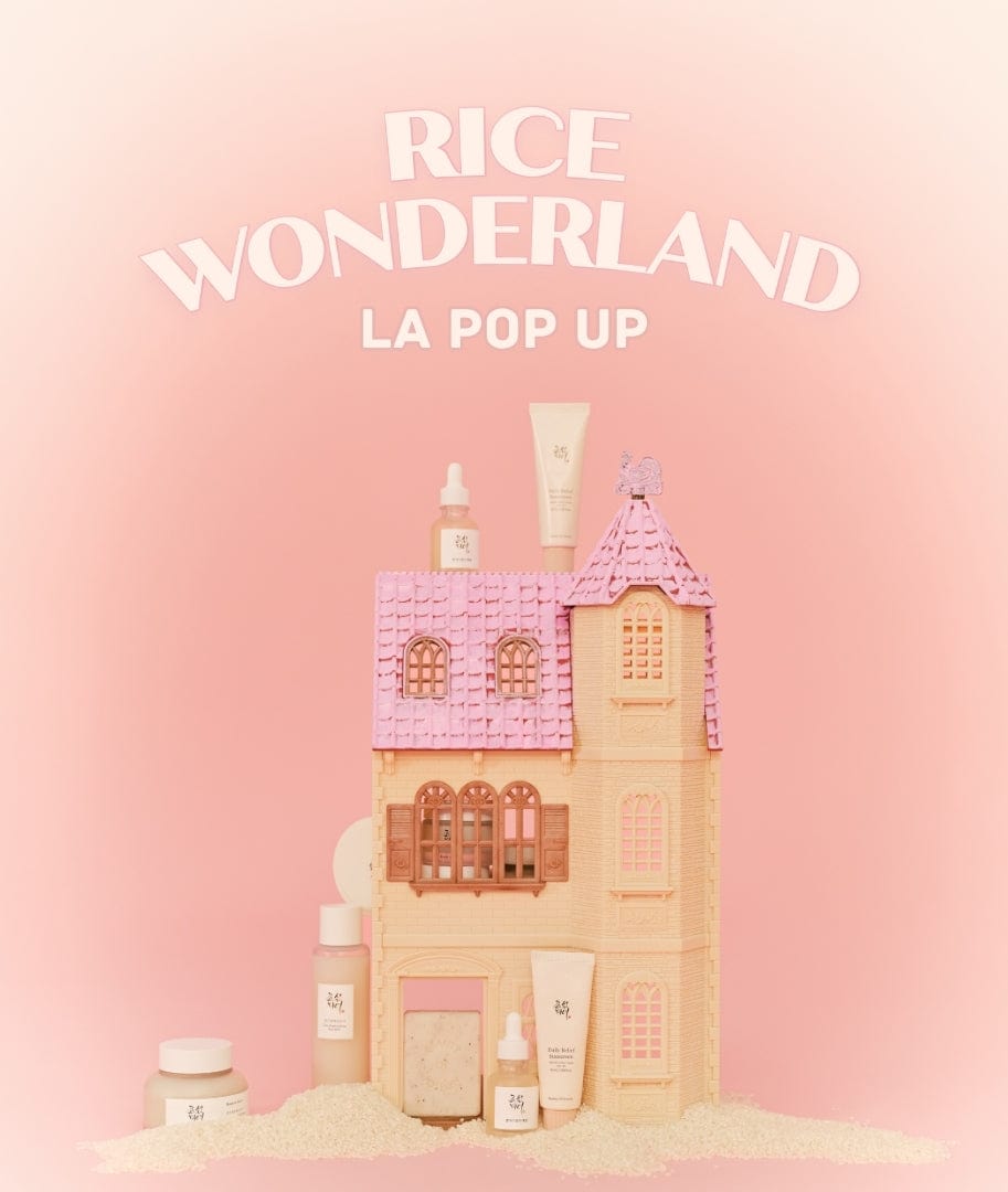 a toy house with a pink roof and a pink background