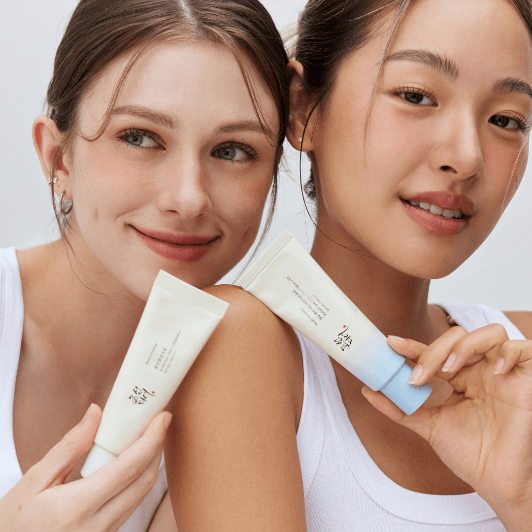 two women holding up some cream