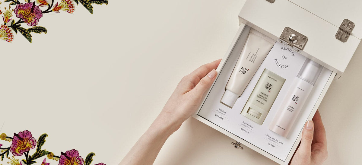 a hand holding a box of cream