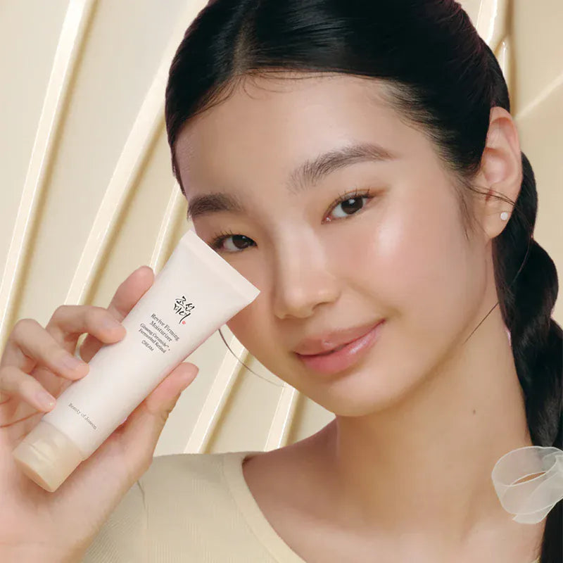 a woman holding a cream tube
