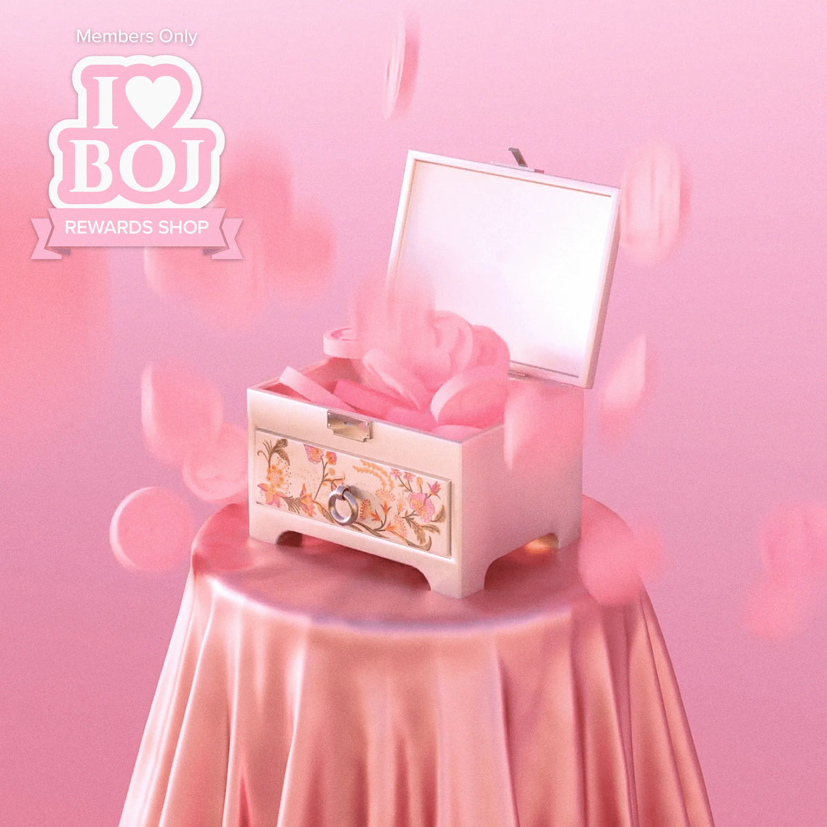 a pink box with a bow on a table