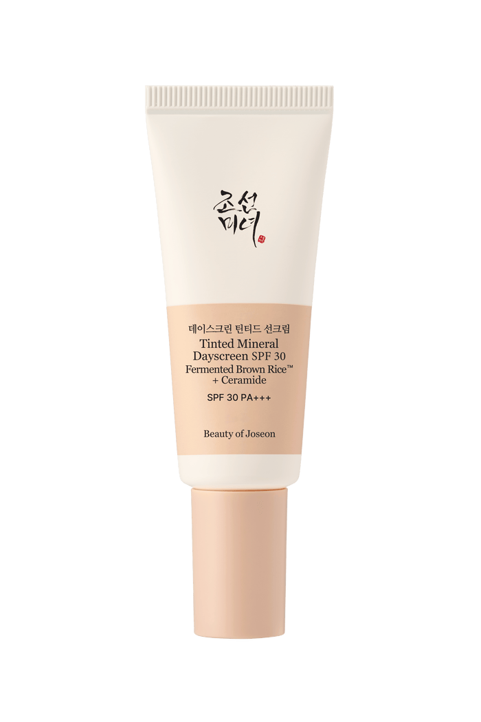 a cream bottle with a black background