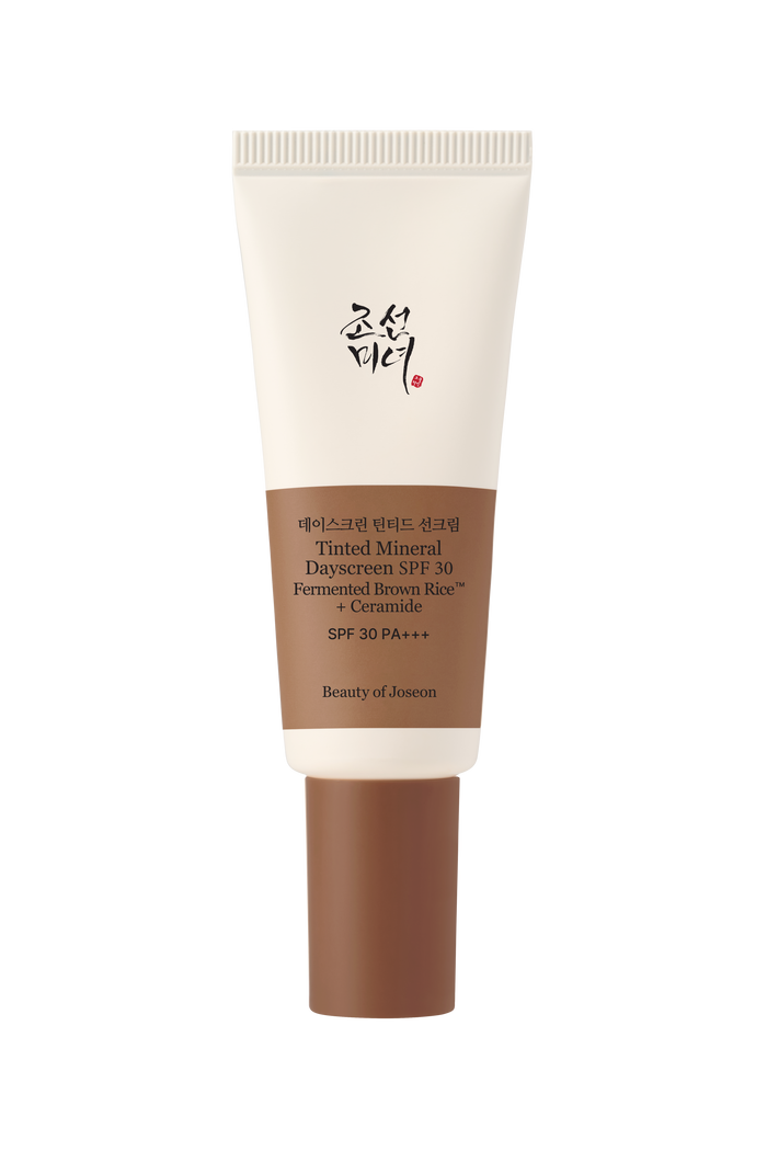a white and brown tube of cream
