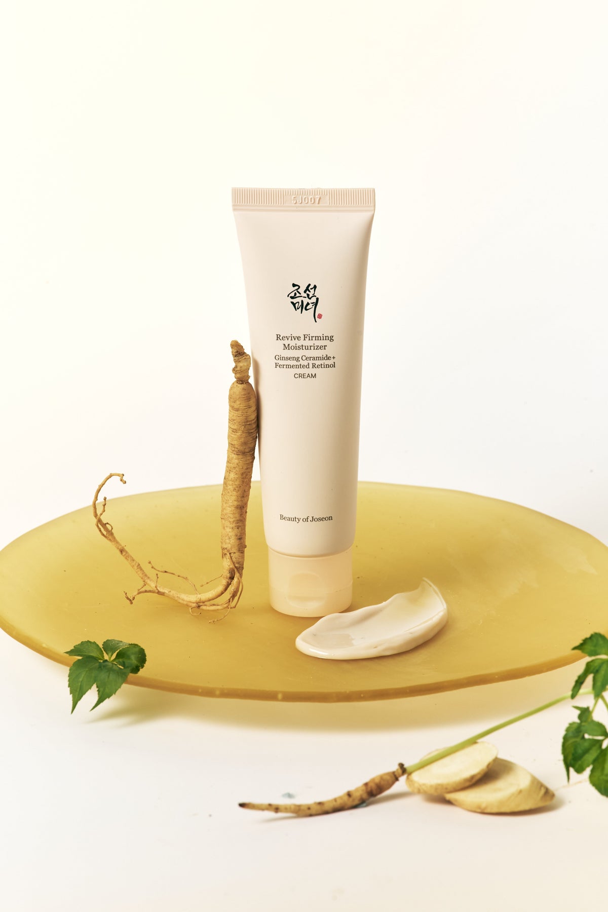 a tube of cream and a root on a plate
