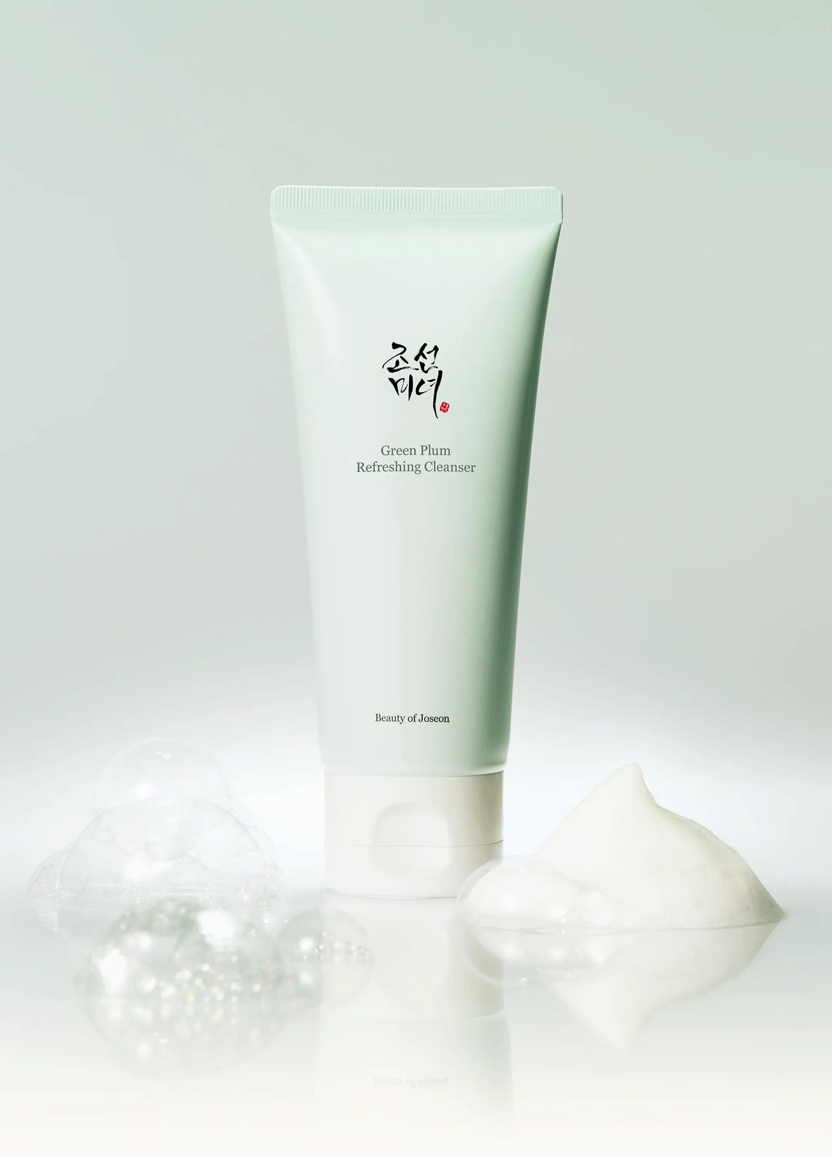 a white tube of cream next to bubbles