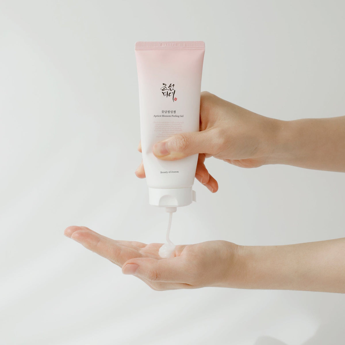 a person pouring a lotion into their hand