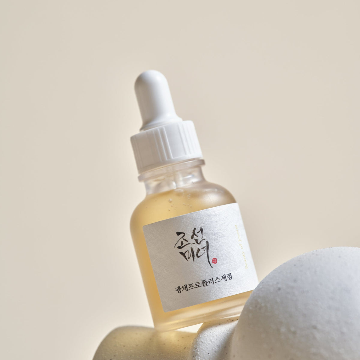 a bottle of liquid on top of a white object