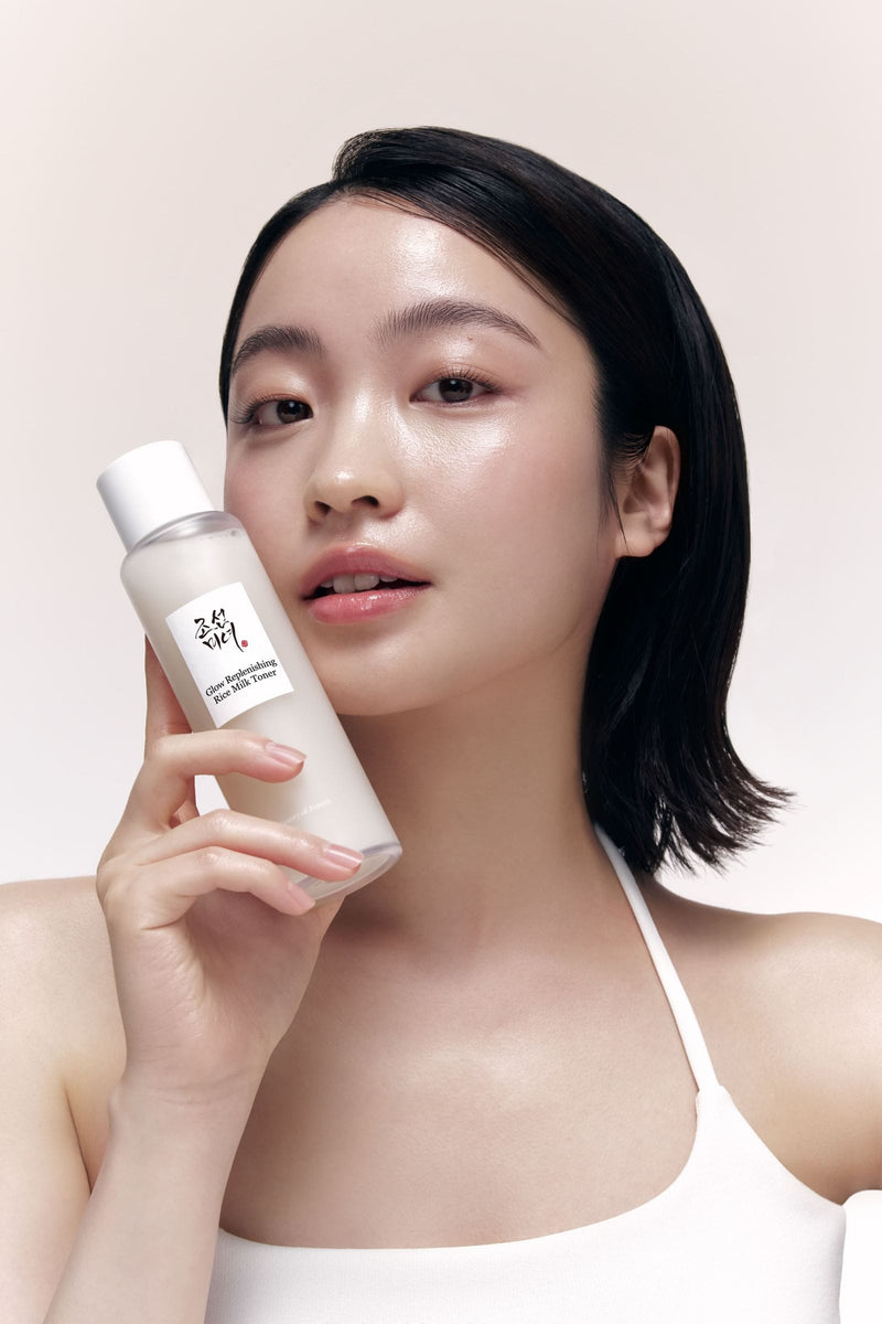 a woman holding a bottle of shampoo