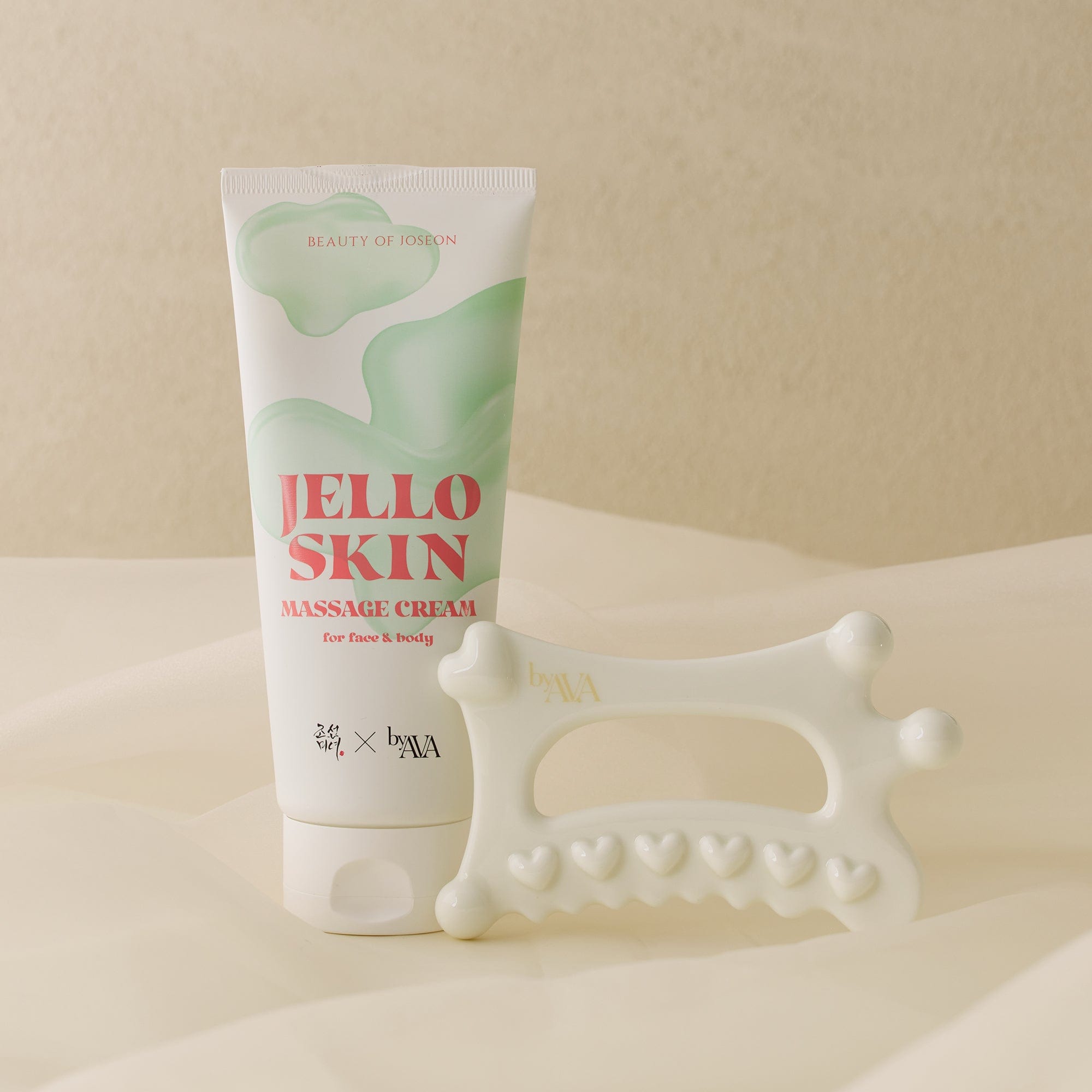 a white tube of cream and a massager