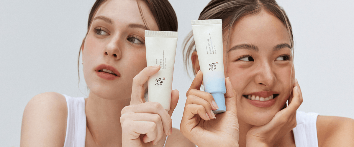 two women holding up a lotion