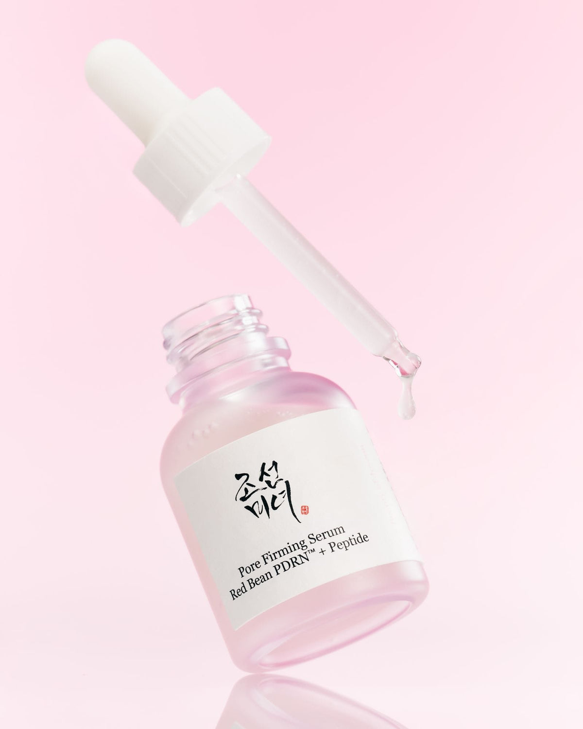 a dropper over a bottle of serum