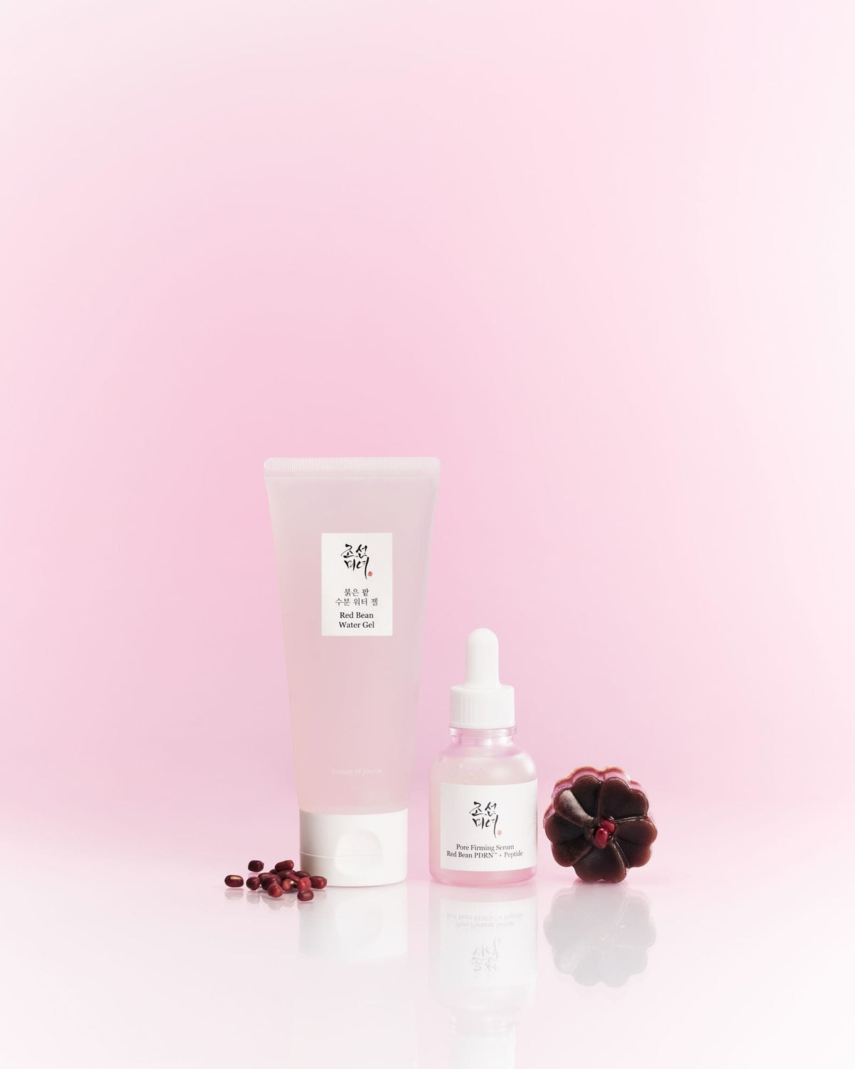 Two skincare products with a pink gradient background