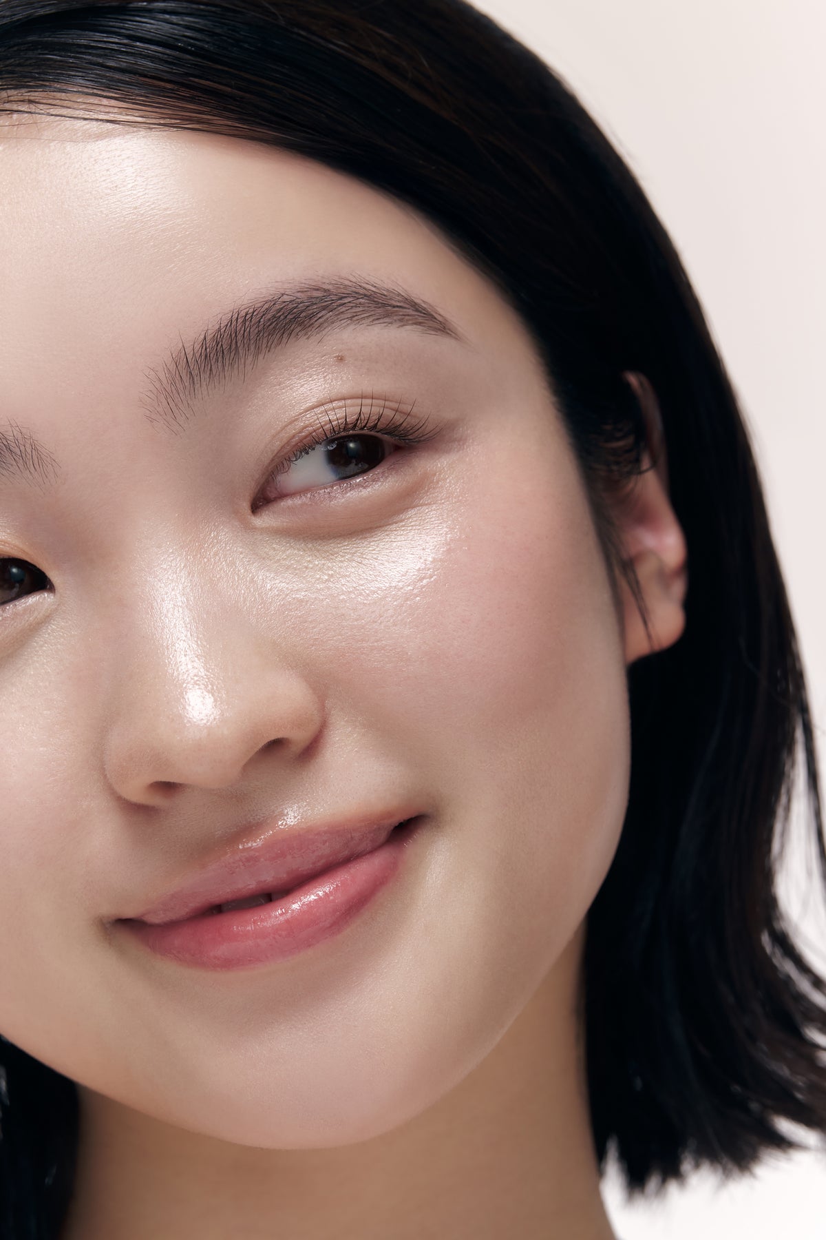 a woman smiling with her eyes closed
