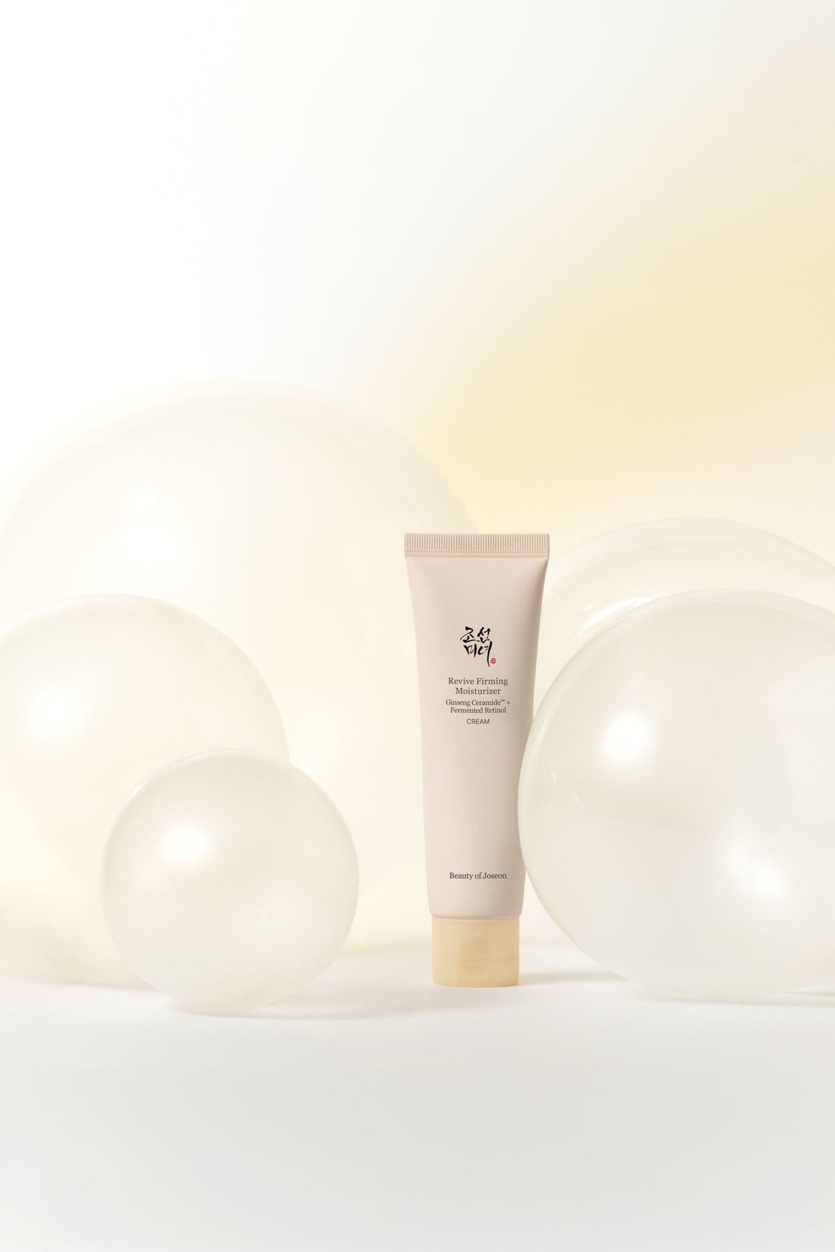 a tube of cream on a white background with white balloons